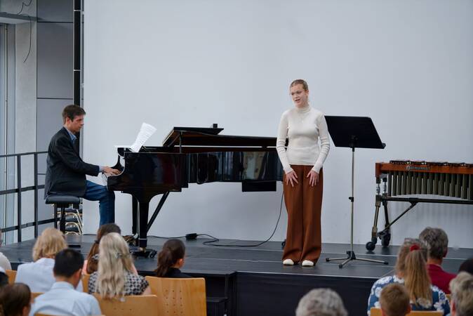 Sängerin begleitet von Pianist auf der Bühne des Bürgersaals.